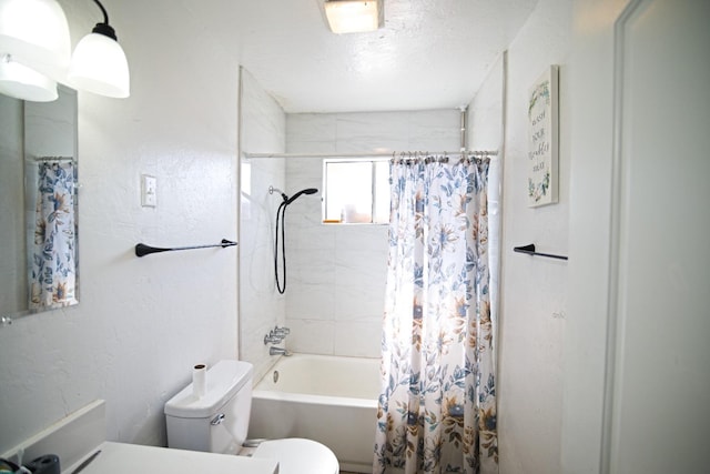 full bathroom featuring toilet, shower / tub combo, and a textured ceiling