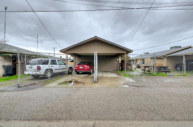 view of front facade with fence and a carport