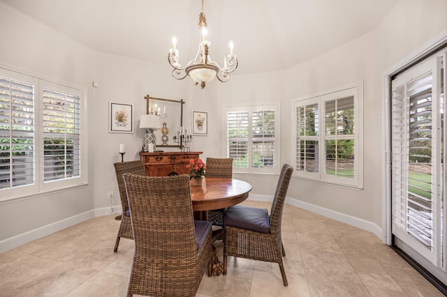 dining area featuring light tile patterned floors and a notable chandelier