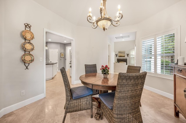 tiled dining area featuring a notable chandelier