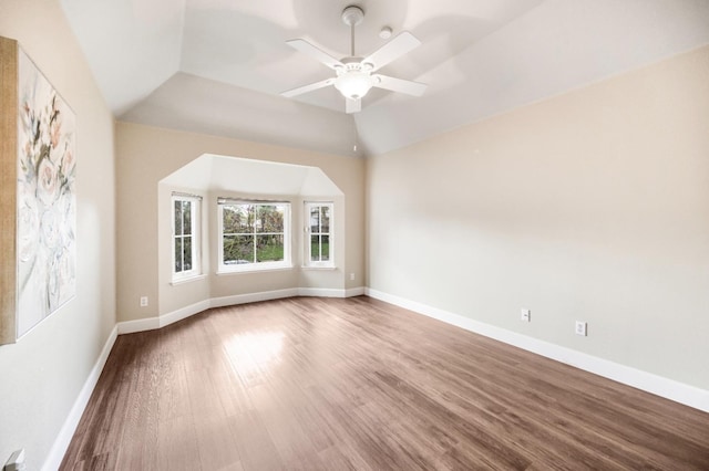 empty room featuring ceiling fan, wood-type flooring, and vaulted ceiling