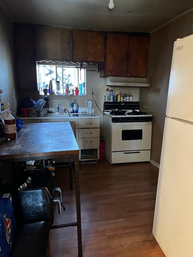13330 E Young Ave, Parlier, CA 93648 - kitchen with under cabinet range hood, white appliances, and wood finished floors
