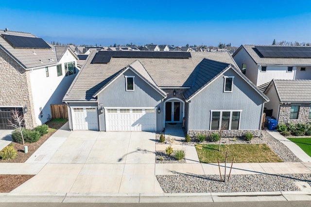 multi unit property featuring a garage and solar panels