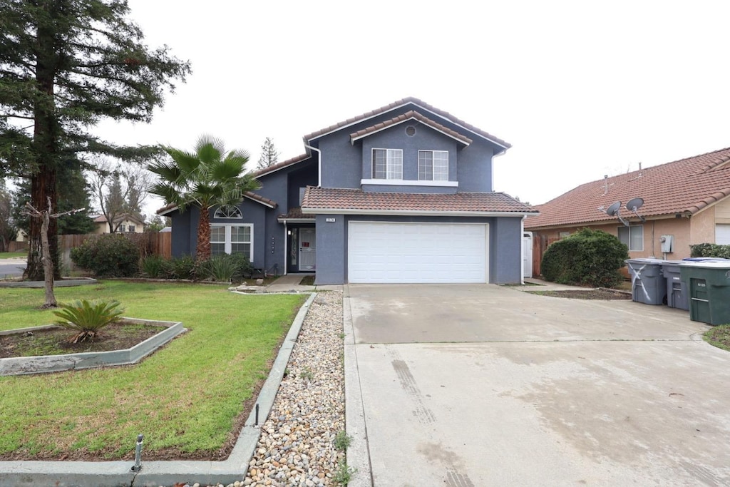 front facade with a garage and a front yard