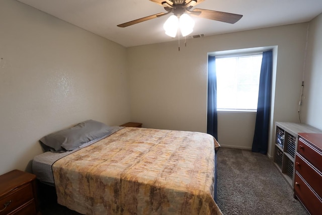 bedroom with ceiling fan and dark colored carpet