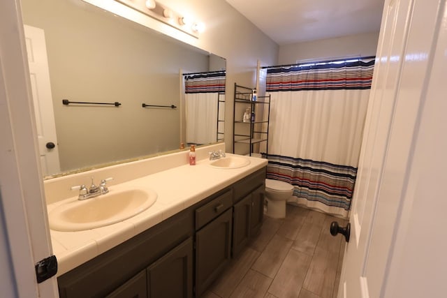 bathroom featuring vanity, toilet, and a shower with shower curtain