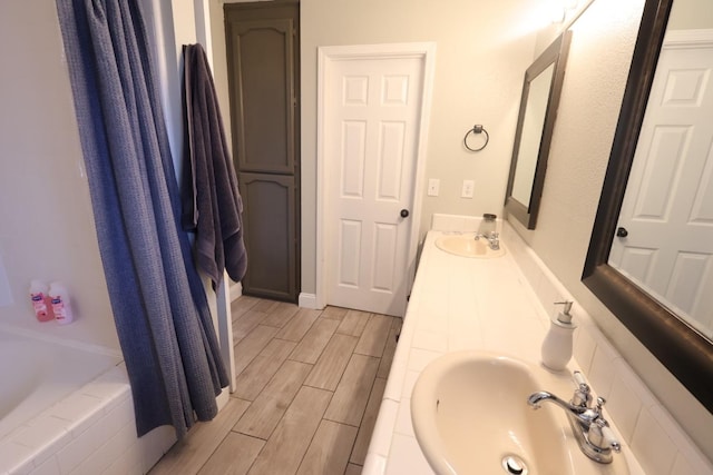 bathroom featuring vanity and independent shower and bath