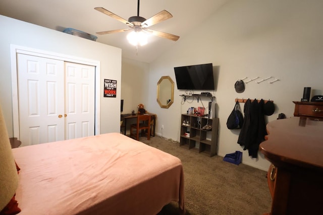 carpeted bedroom featuring ceiling fan, vaulted ceiling, and a closet