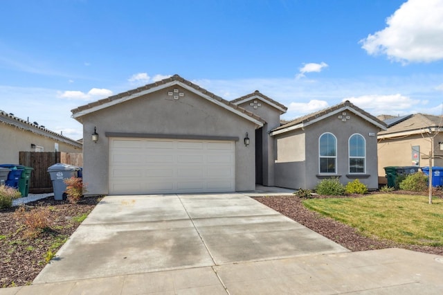 view of front of house featuring an attached garage, a tile roof, driveway, stucco siding, and a front lawn