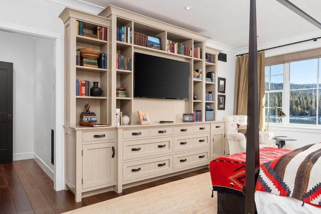 bedroom with ornamental molding and dark hardwood / wood-style flooring