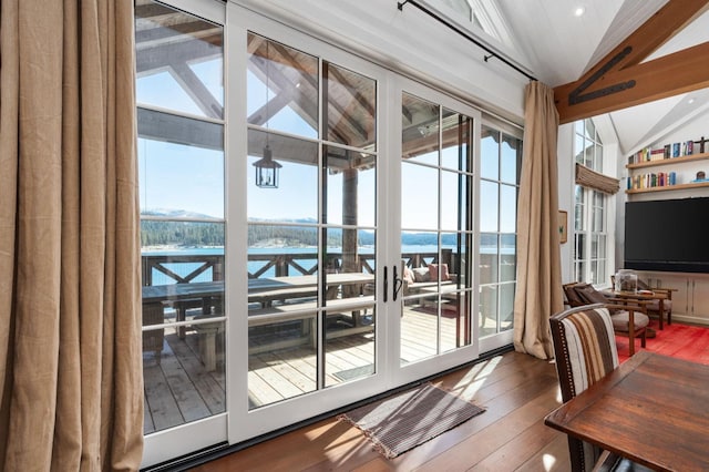 doorway to outside with hardwood / wood-style flooring and vaulted ceiling