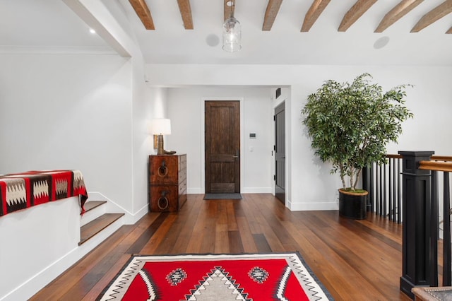 entrance foyer featuring beamed ceiling and dark hardwood / wood-style flooring