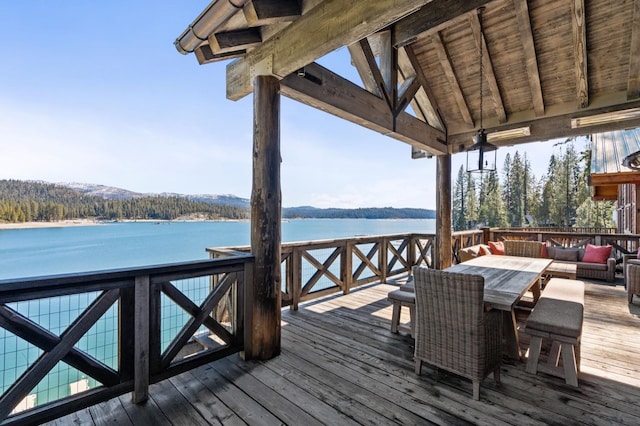 deck with a water view and an outdoor hangout area
