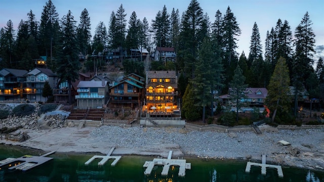 rear view of house featuring a water view