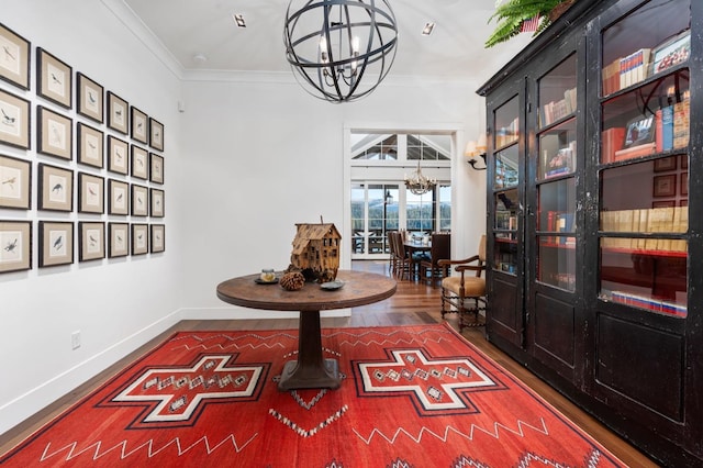 hallway featuring an inviting chandelier, dark wood-type flooring, and ornamental molding