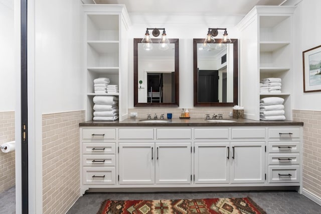 bathroom with vanity, tile walls, and built in shelves
