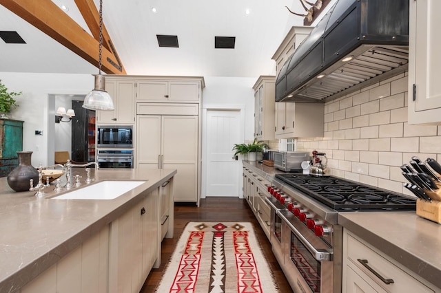 kitchen featuring pendant lighting, sink, backsplash, exhaust hood, and built in appliances