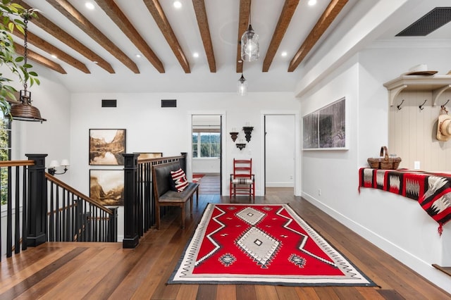 game room featuring dark wood-type flooring and beamed ceiling