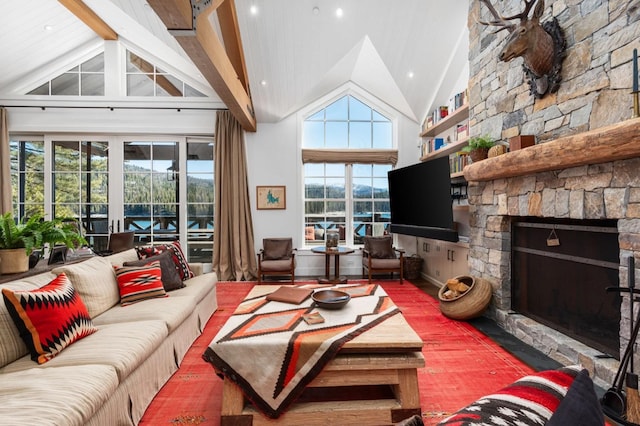living room featuring a stone fireplace and high vaulted ceiling