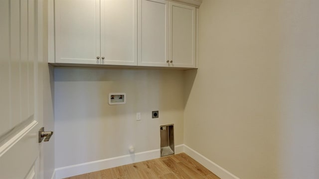 clothes washing area with cabinets, light hardwood / wood-style floors, hookup for a washing machine, and electric dryer hookup