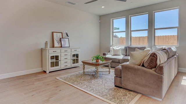 living room with ceiling fan and light hardwood / wood-style floors