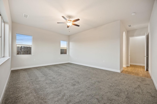 unfurnished room featuring ceiling fan and light colored carpet