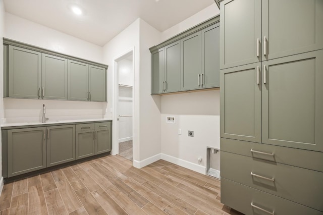 clothes washing area with cabinets, hookup for a washing machine, hookup for an electric dryer, hookup for a gas dryer, and light hardwood / wood-style floors