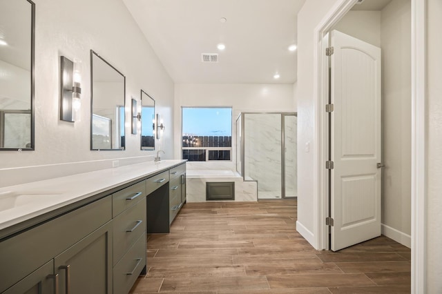 bathroom featuring vanity and shower with separate bathtub