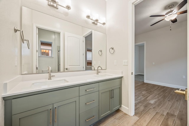 bathroom with wood-type flooring, vanity, and ceiling fan