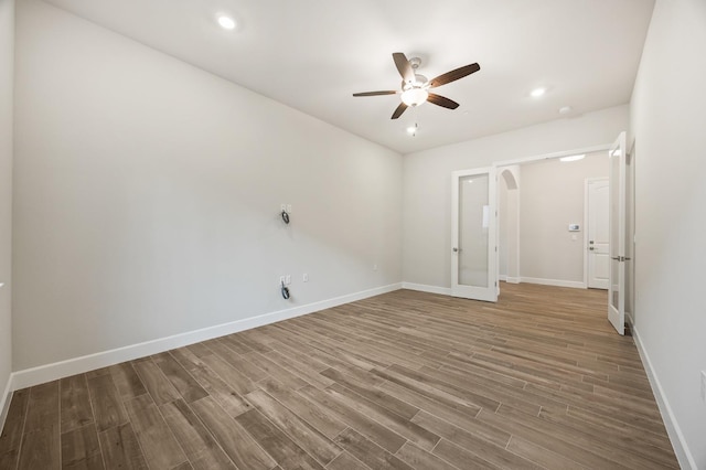 spare room with hardwood / wood-style flooring and ceiling fan