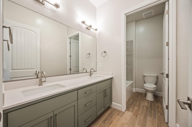 full bathroom featuring vanity, toilet, and  shower combination