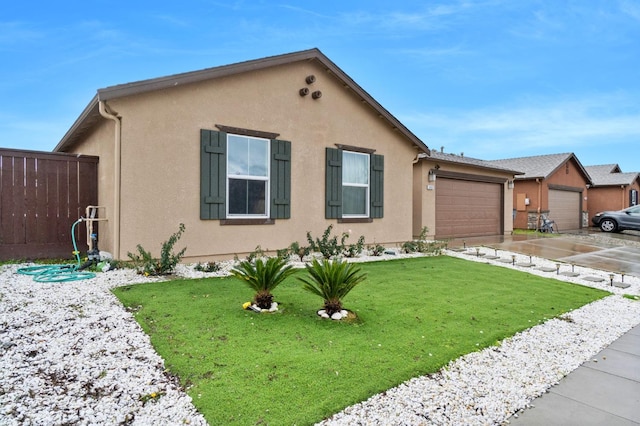 view of front of house with a garage and a front lawn