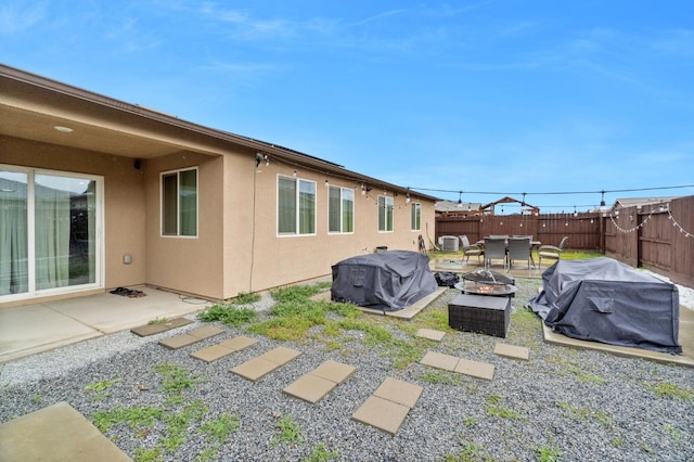 exterior space with a patio area and a fire pit