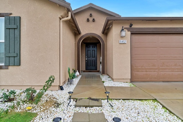 doorway to property with a garage