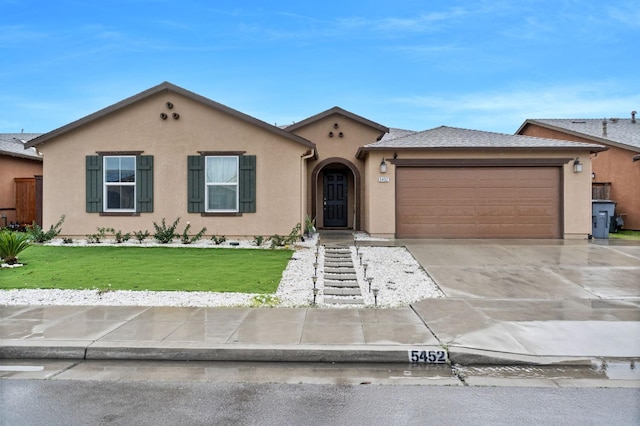 view of front of house featuring a garage and a front lawn