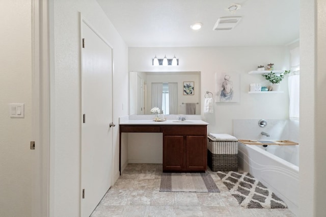 bathroom featuring vanity and a bath