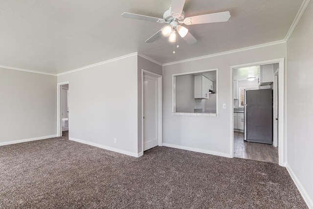 unfurnished living room featuring crown molding, baseboards, a ceiling fan, and carpet