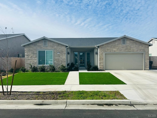 view of front of house featuring driveway, stone siding, french doors, an attached garage, and a front yard