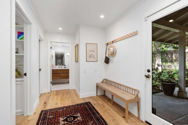 hallway featuring ornamental molding and light wood-type flooring