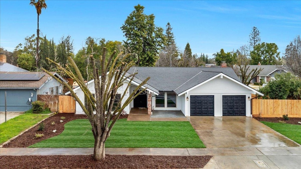 ranch-style house with a garage and a front lawn