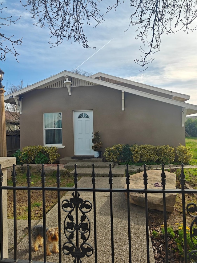 view of front of property featuring a fenced front yard and stucco siding