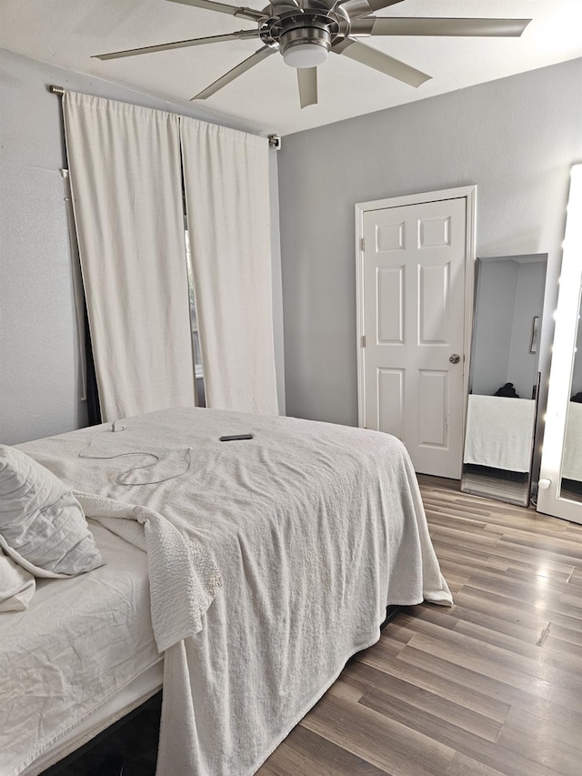 bedroom with ceiling fan and wood finished floors