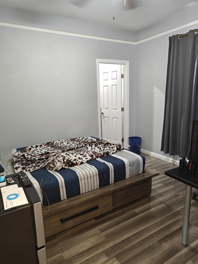 bedroom featuring baseboards and dark wood-style flooring