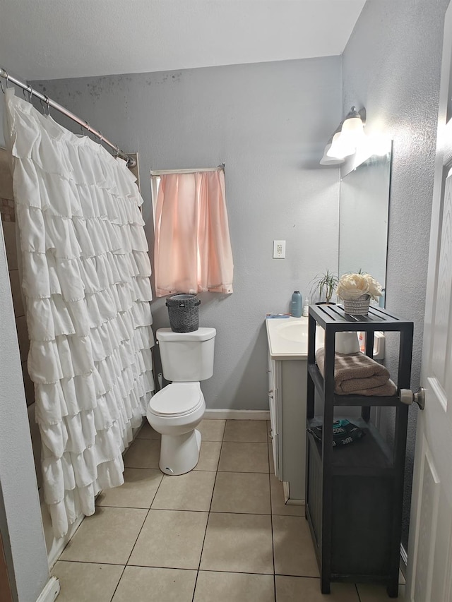 full bathroom with tile patterned flooring, toilet, vanity, baseboards, and a shower with curtain