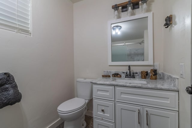 full bath featuring toilet, baseboards, and vanity