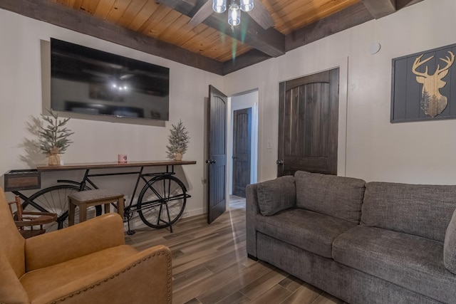 living room featuring baseboards, wood ceiling, ceiling fan, wood finished floors, and beamed ceiling