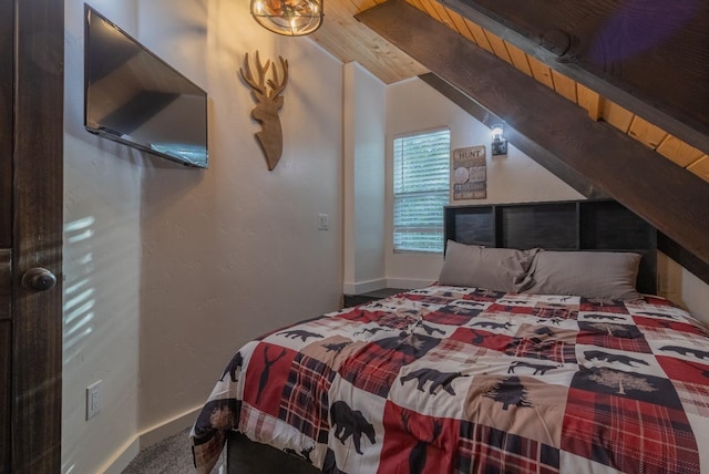 bedroom featuring beamed ceiling and baseboards