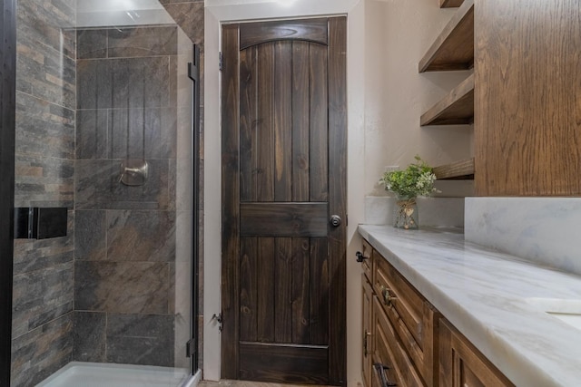 bathroom featuring a stall shower and vanity