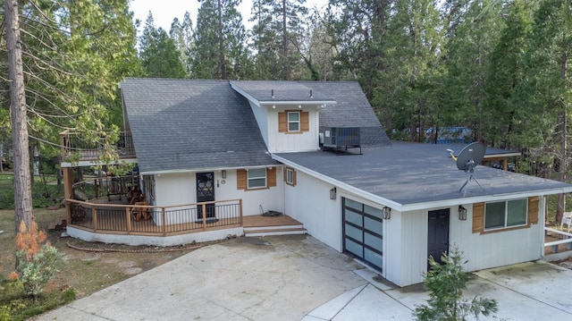 view of front of property featuring concrete driveway, a shingled roof, and central air condition unit