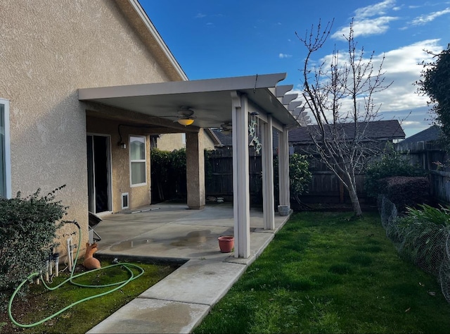 view of yard with ceiling fan and a patio area